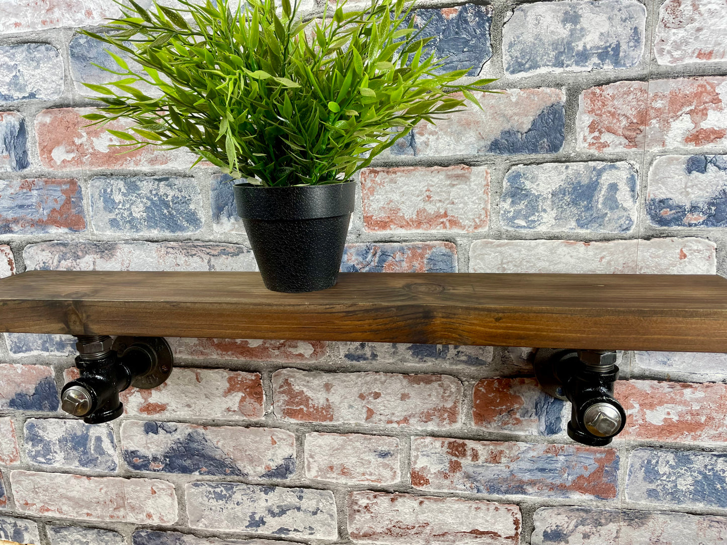 20cm x 10cm handmade industrial style shelf with metal pipework brackets.
Made from solid wood and metal industrial style pipework, this unit is perfect for industrial or loft living style home decor and suitable to use anywhere around the home.