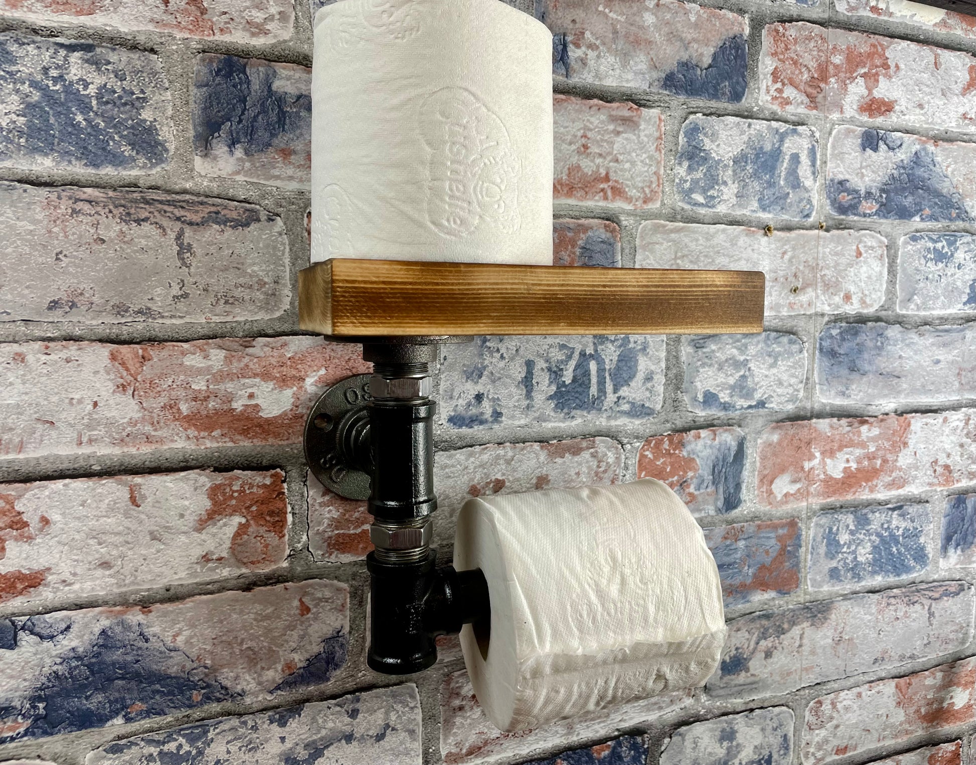 Industrial Style Pipework Toilet Roll Holder.

Made to order industrial style pipework toilet roll holder with solid wood shelf in a choice of colours.