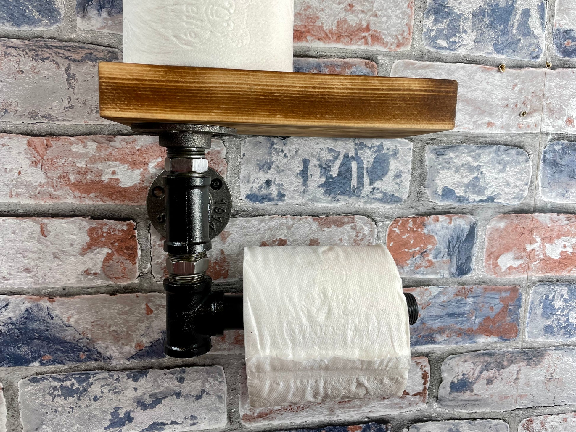 Industrial Style Pipework Toilet Roll Holder.

Made to order industrial style pipework toilet roll holder with solid wood shelf in a choice of colours.